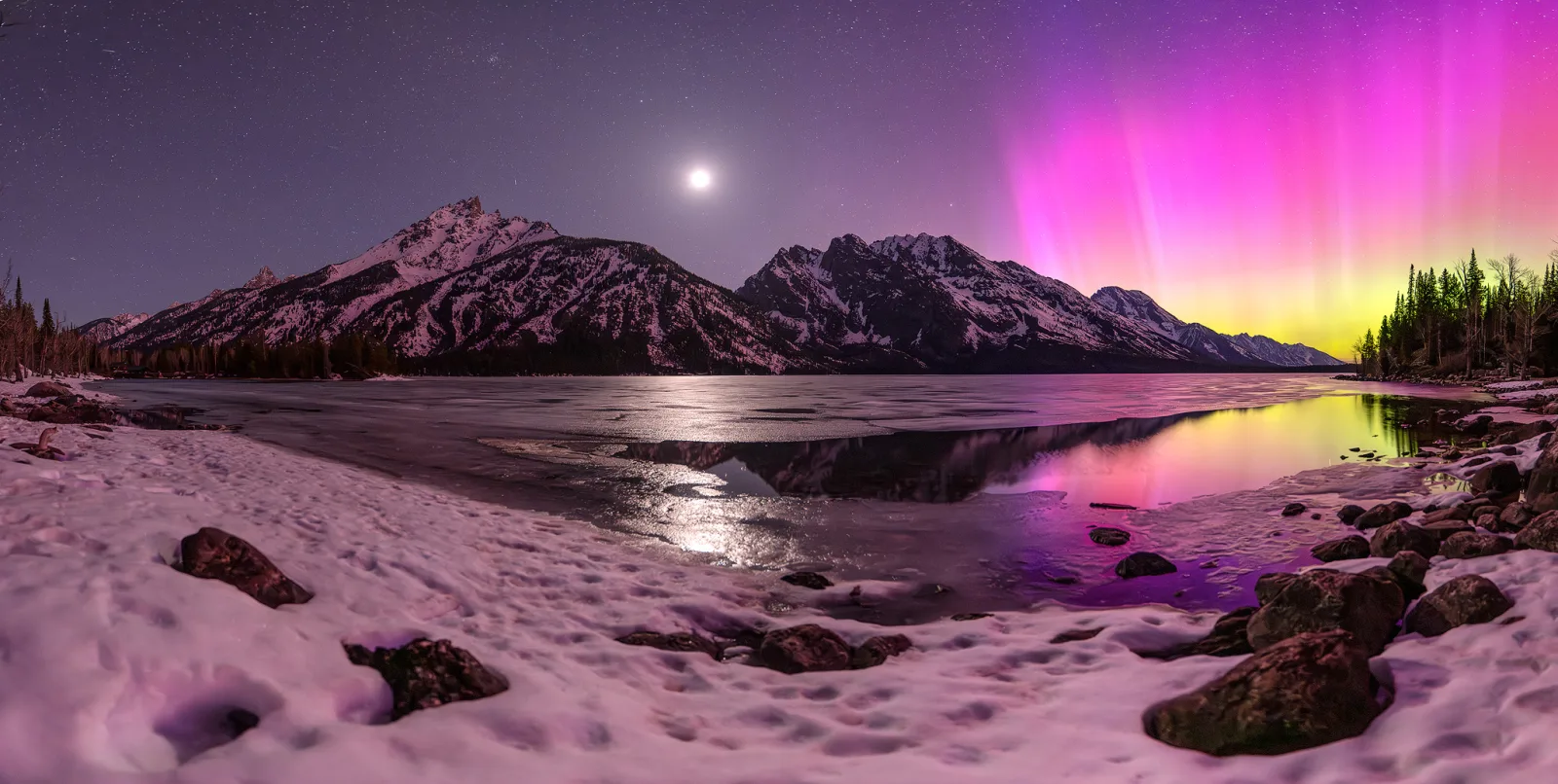 A panorama taken from Jenny Lake with a surprise appearance of the aurora borealis inside Grand Teton National Park.