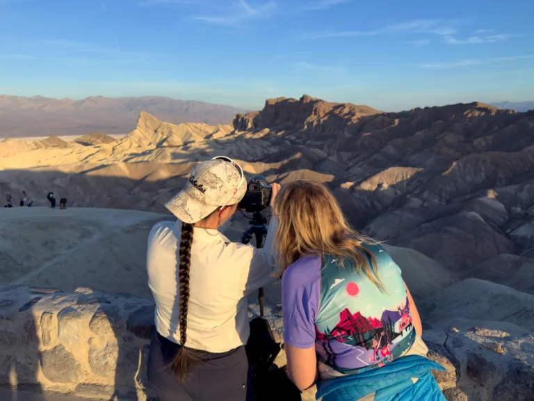 Evie Wilder helping participants and explaining camera settings at Zabriskie Point overlooking the badlands.
