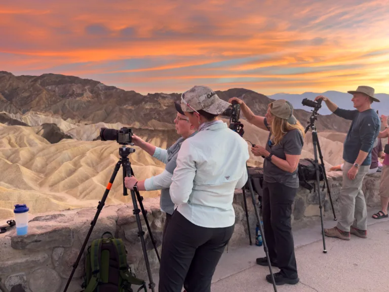 Evie Wilder helps students with their cameras during an explosive sunset at Zabriskie Point.