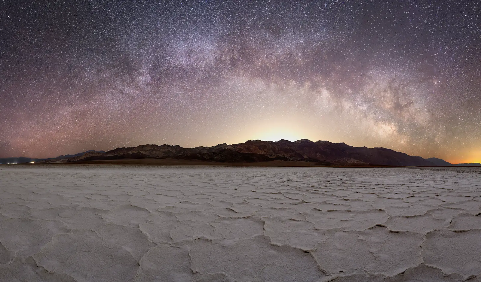A panorama of the Milky Way Galaxy over the salt pans of Death Valley National Park during the night photography workshop