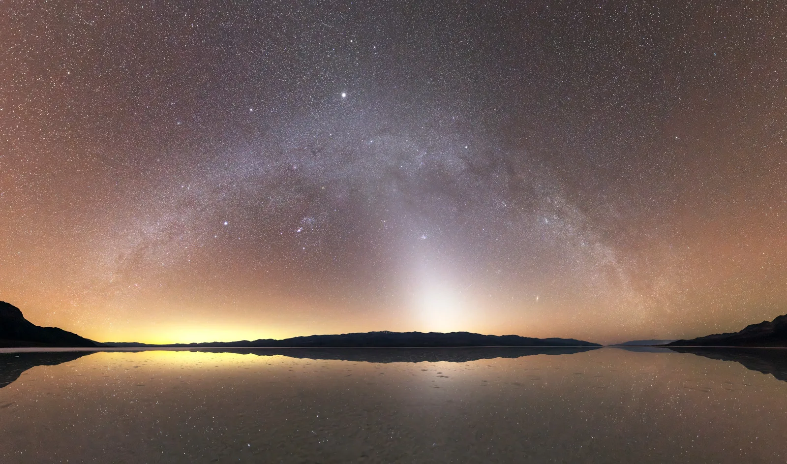 Zodiacal light and the Milky Way reflect off Lake Manly in Badwater Basin in Death Valley National Park.